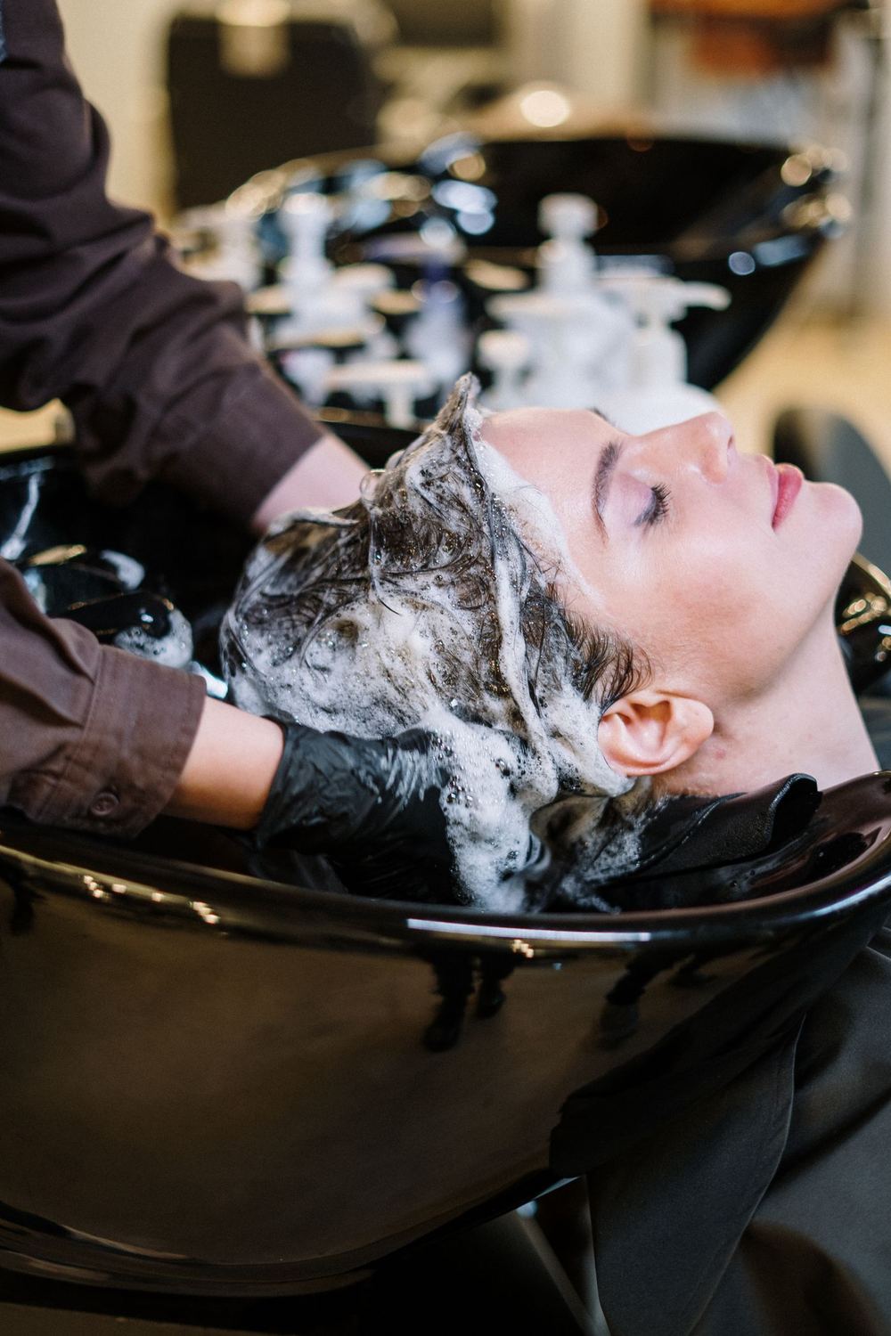 Client having her hair washed at the basin